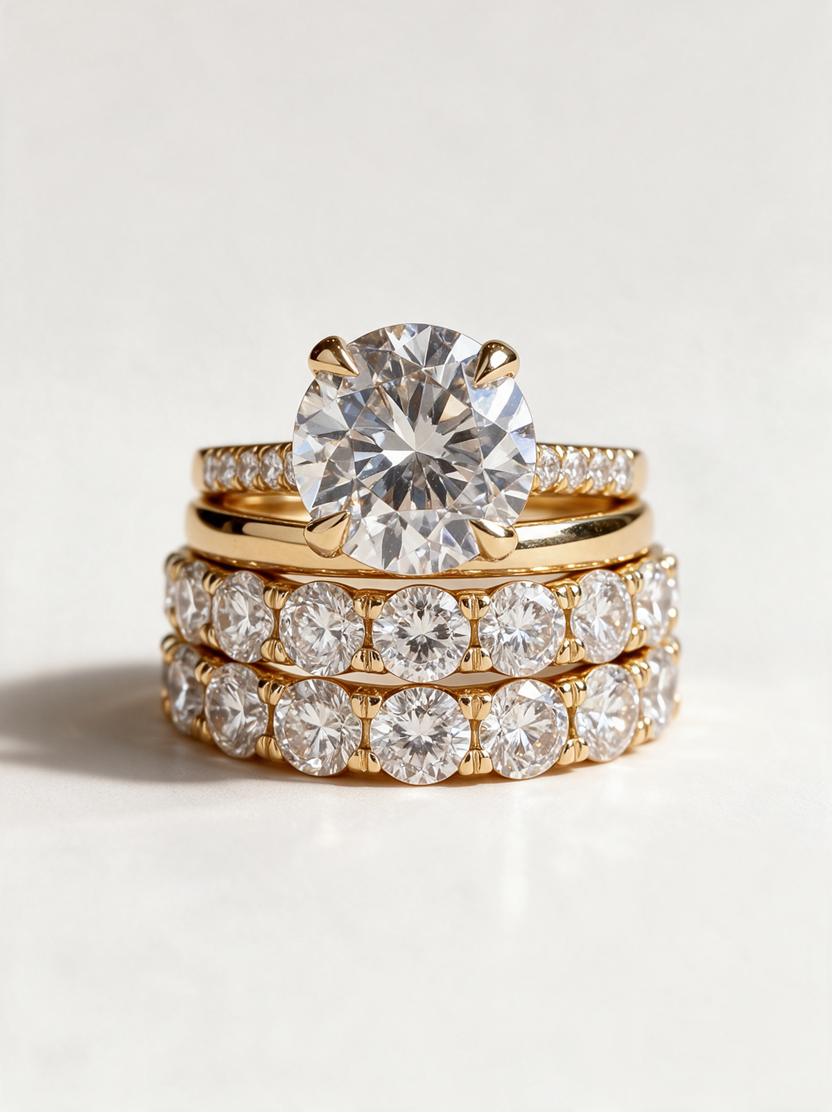 Set of three gold zirconia stackable rings on a neutral background
