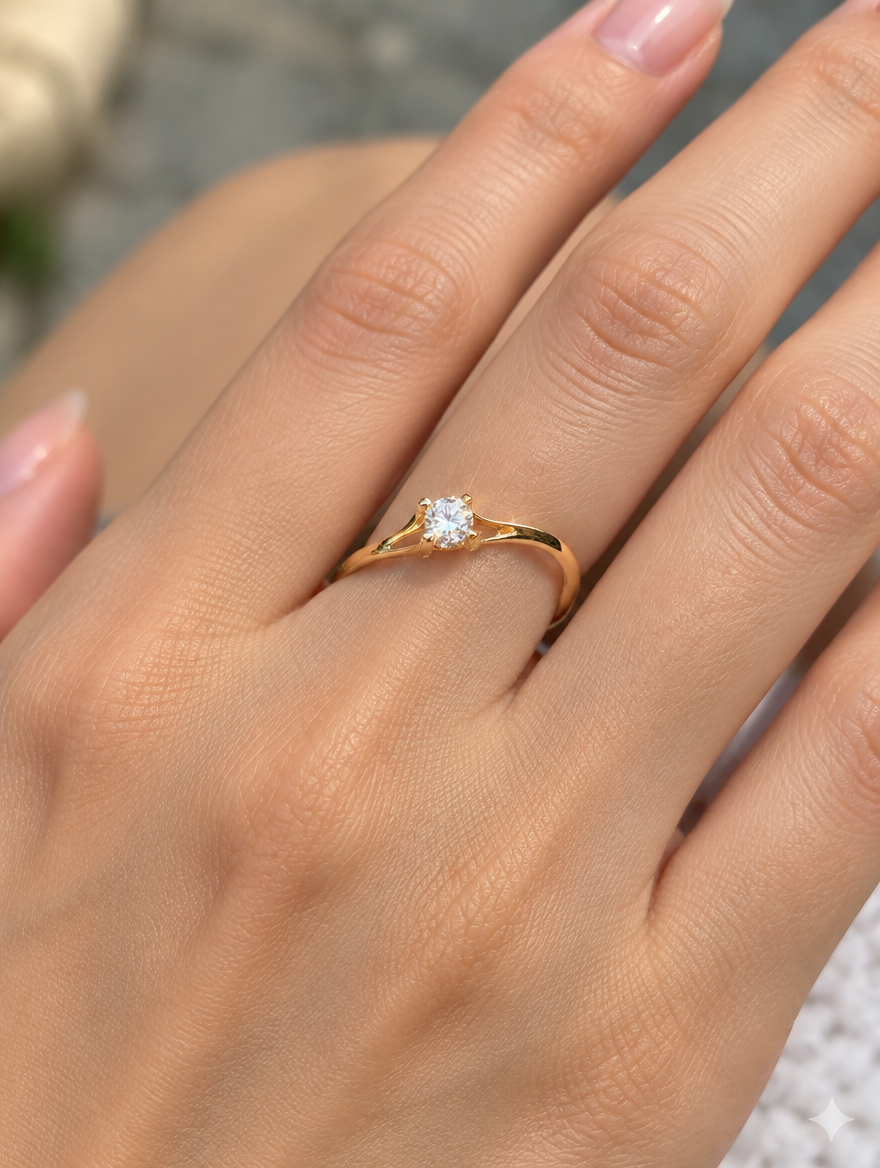 Woman wearing a gold solitaire zirconia ring on her finger