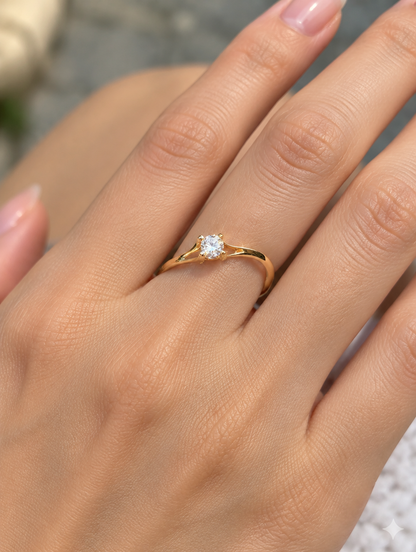 Woman wearing a gold solitaire zirconia ring on her finger