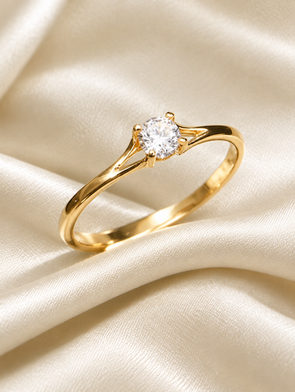 Gold solitaire zirconia ring resting on a soft textured surface