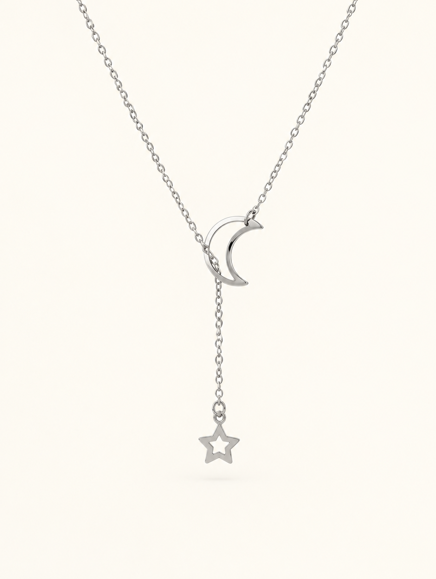 Silver-tone moon and star lariat necklace on a neutral background