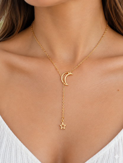 Woman wearing a gold-tone lariat necklace with a crescent moon and star