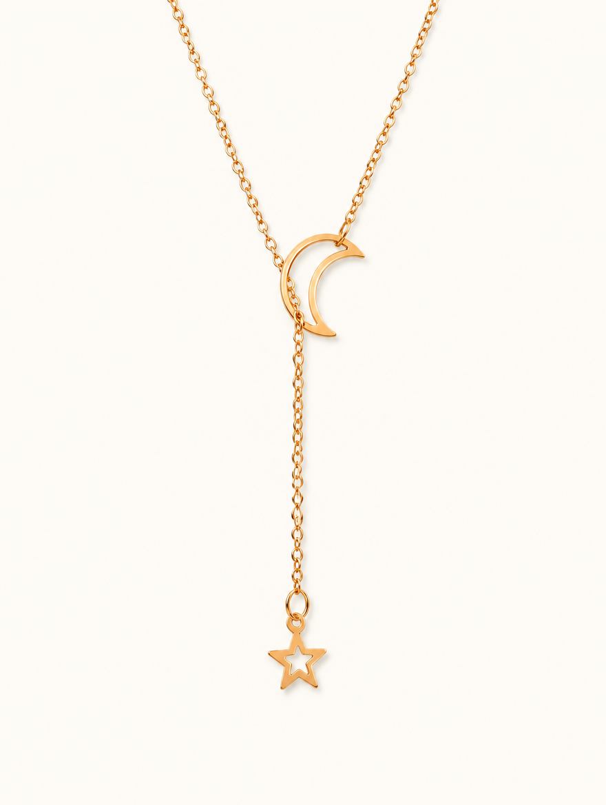 Gold-tone moon and star lariat necklace on a neutral background
