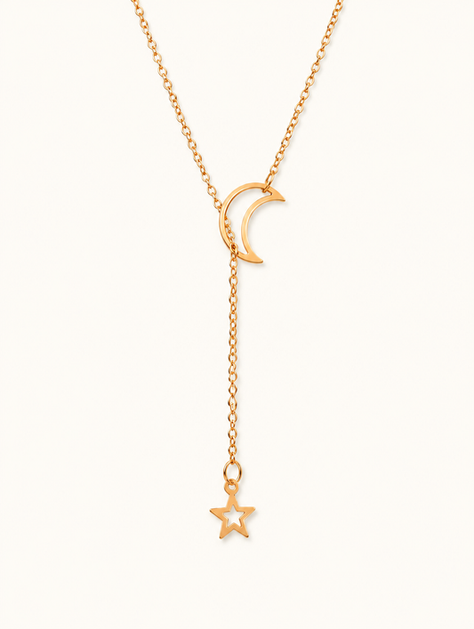 Gold-tone moon and star lariat necklace on a neutral background