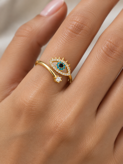 Woman wearing a gold evil eye zirconia ring on her finger