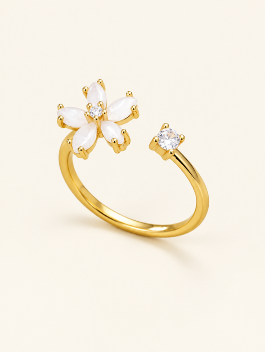Gold flower zirconia ring on a neutral background