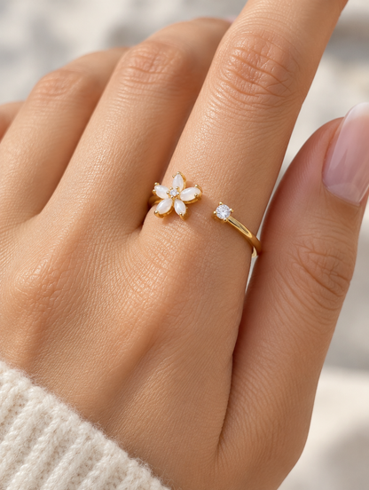 Woman wearing a gold flower zirconia ring on her finger