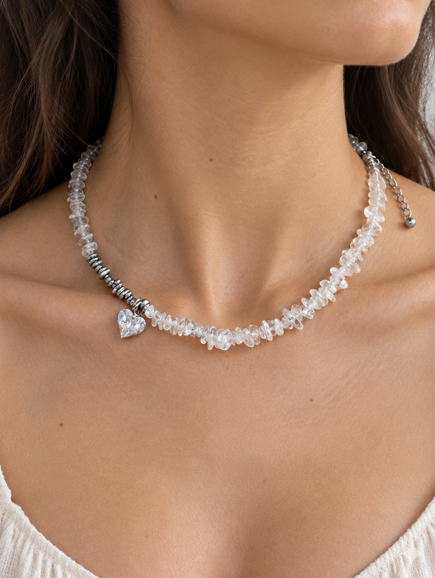 Woman wearing a clear chip bead choker necklace with a small heart charm