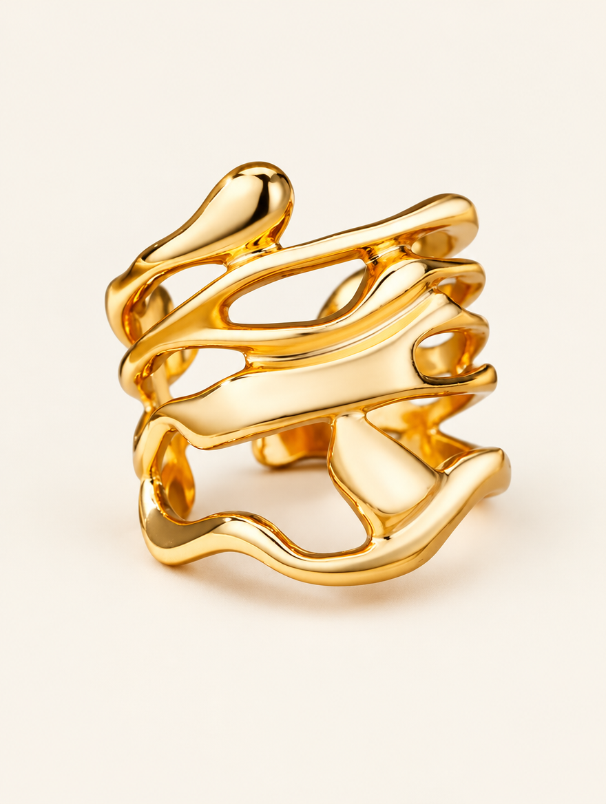 Wide gold wavy open ring on a neutral background