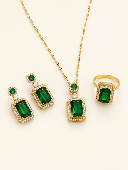 Emerald green crystal necklace, drop earrings and ring set on a neutral background