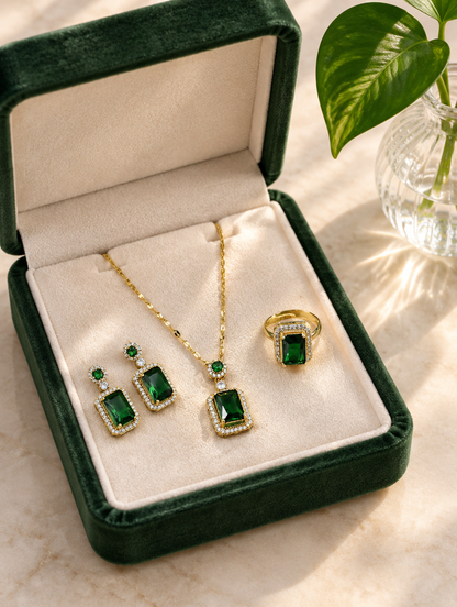 Green crystal necklace, earrings and ring in an open dark green jewellery box