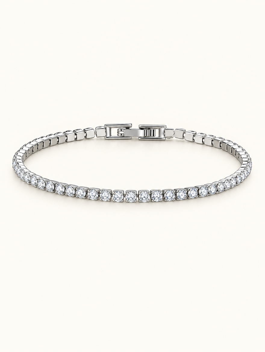 Silver zirconia tennis bracelet with a single row of clear stones on a neutral background