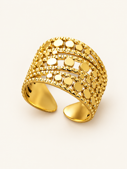 Wide gold disc texture open ring on a neutral background