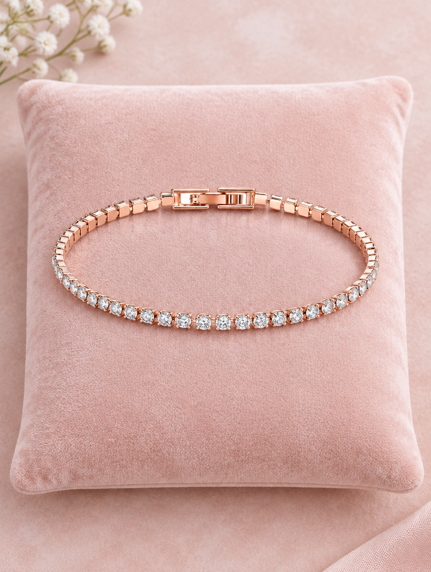 Rose gold tennis bracelet on a blush pink velvet cushion