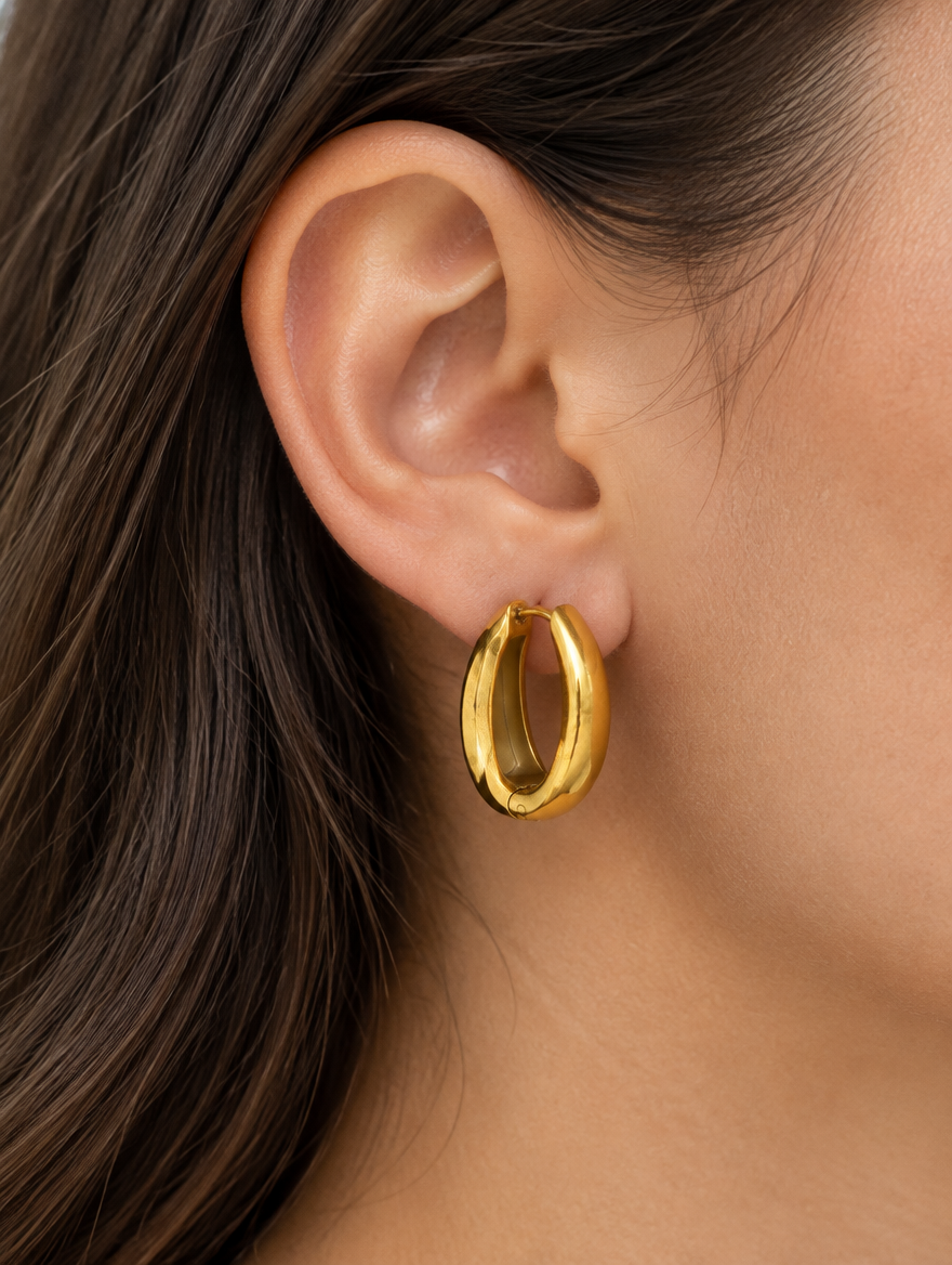Woman wearing a 316l steel gold huggie hoop earring