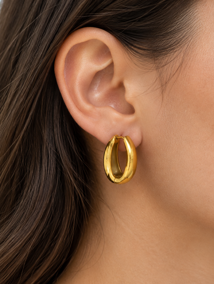 Woman wearing a 316l steel gold huggie hoop earring