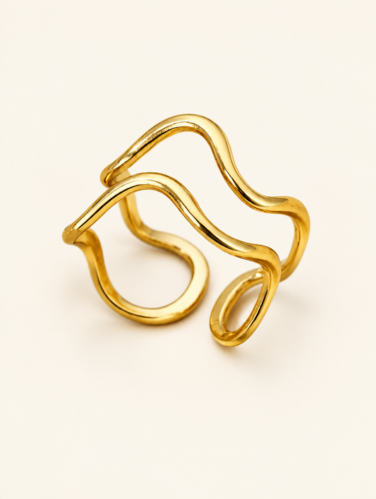 Gold swirl loop open ring on a neutral background