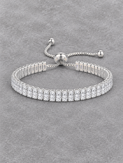 Silver slider tennis bracelet with two rows of stones on grey velvet