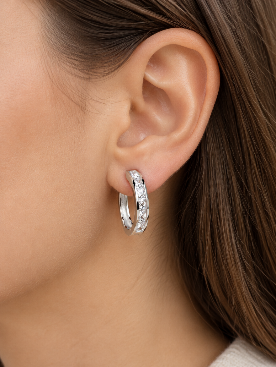 Woman wearing a silver princess-cut zirconia hoop earring