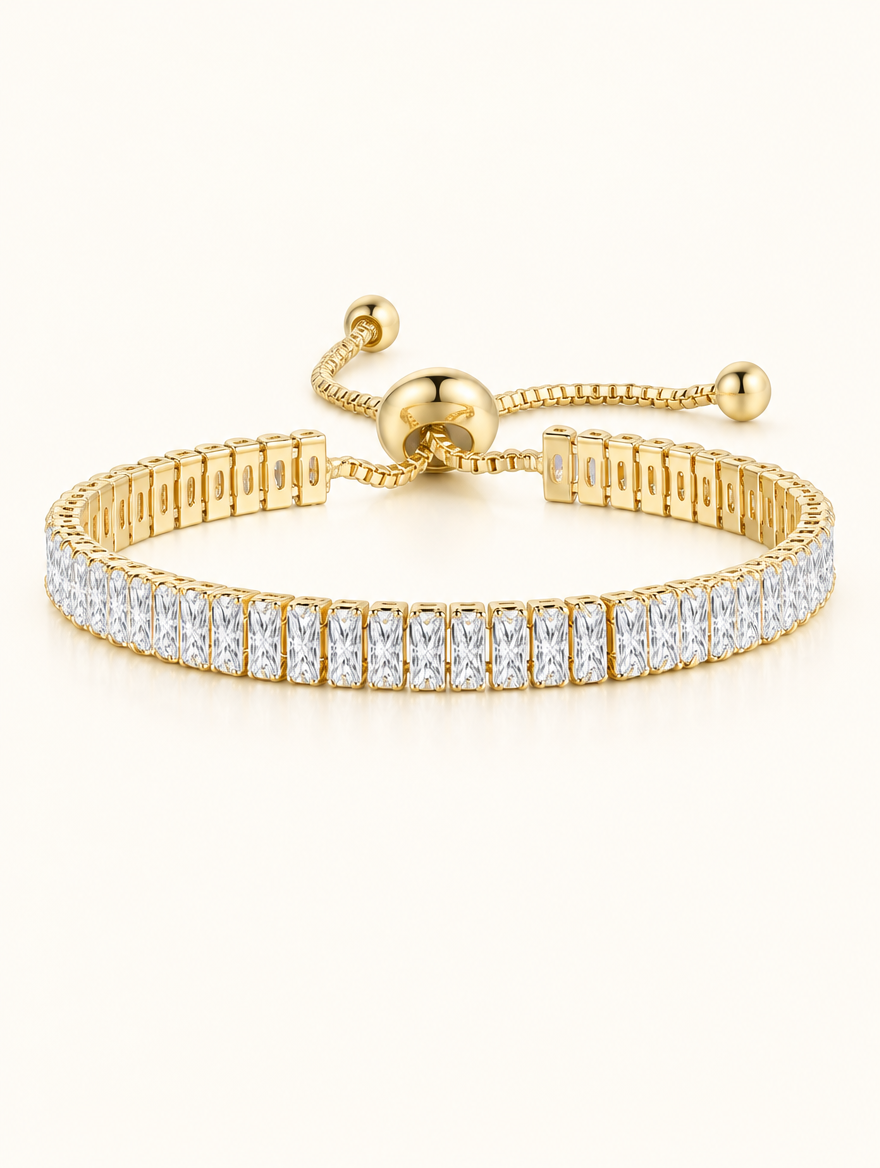 Gold baguette zirconia slider tennis bracelet on a neutral background