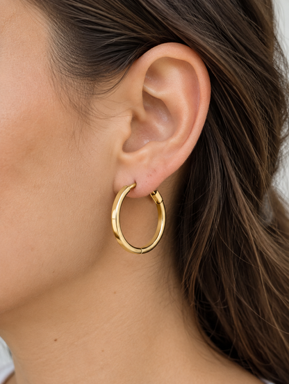 Woman wearing a classic gold-tone round hoop earring