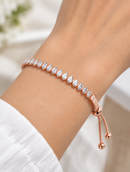 Woman wearing a rose gold pear zirconia slider bracelet
