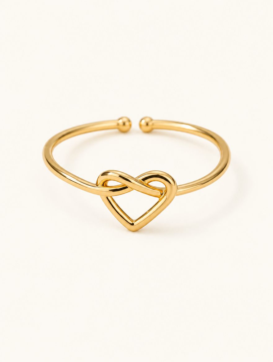 Gold open heart ring on a neutral background
