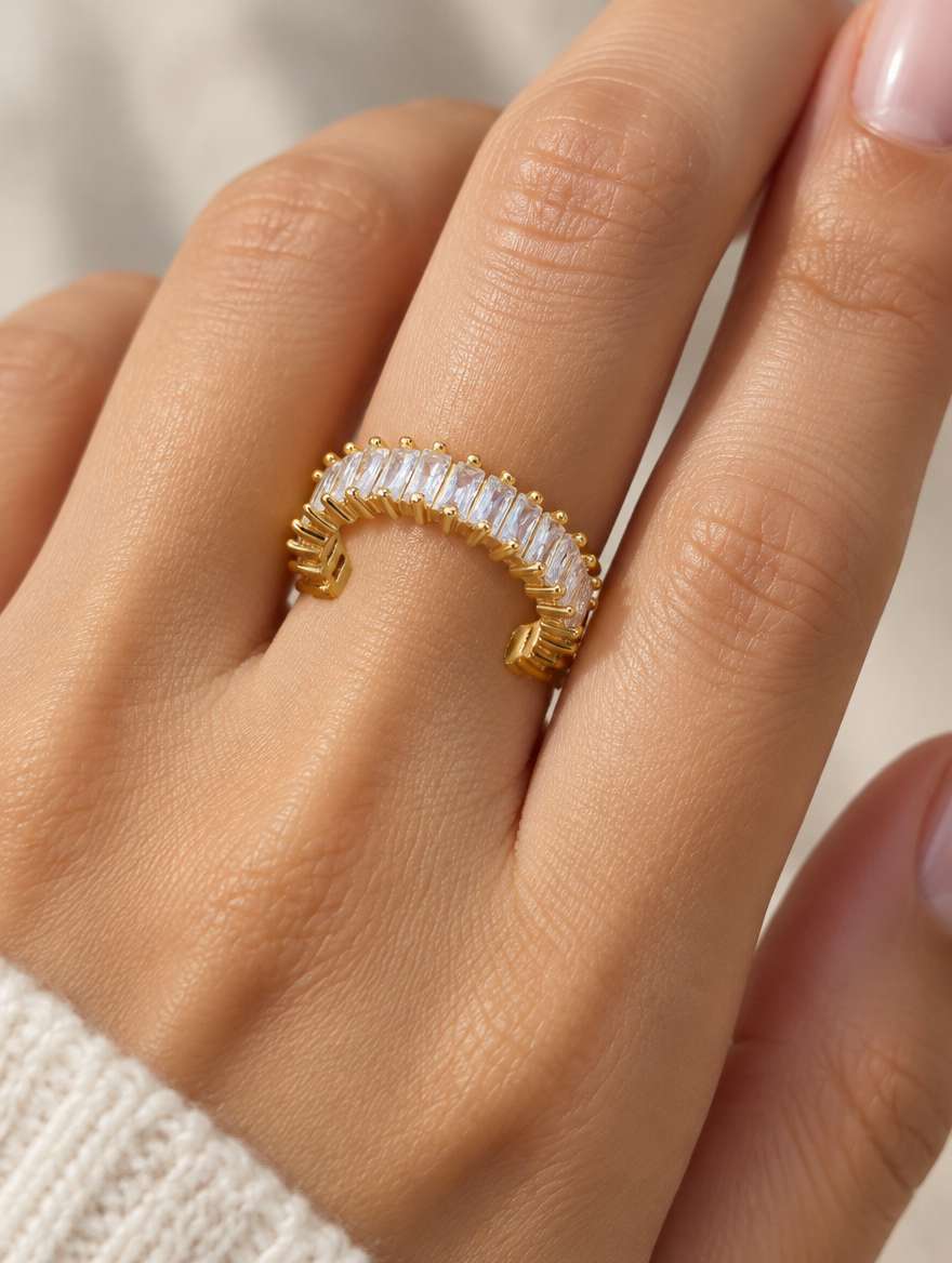 Woman wearing a gold baguette clear stone ring on her finger