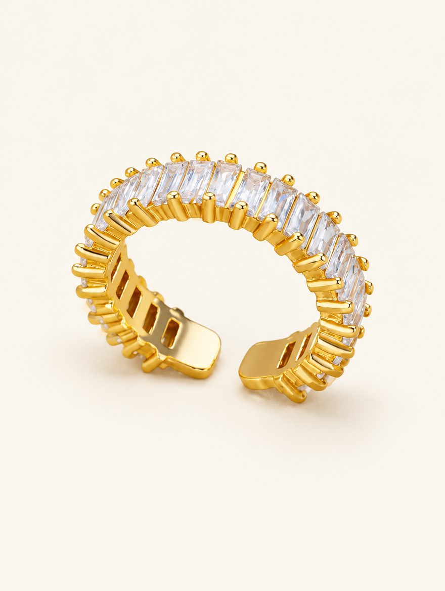 Gold baguette clear stone ring on a neutral background