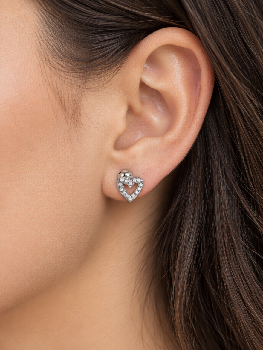 Woman wearing a silver open heart stud earring