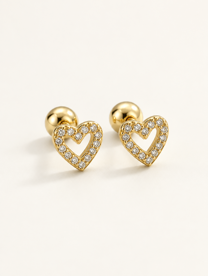 Pair of gold open heart stud earrings on a warm off-white background
