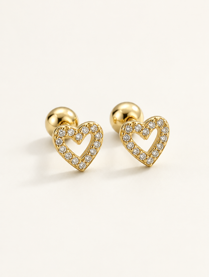 Pair of gold open heart stud earrings on a warm off-white background