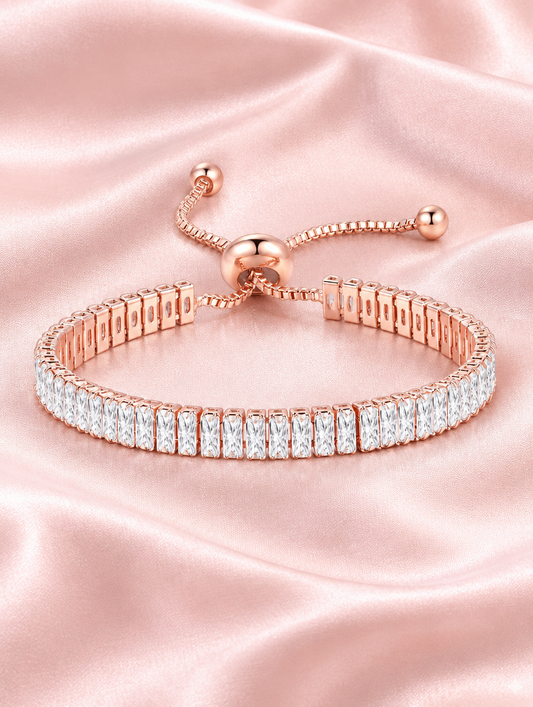Rose gold slider tennis bracelet with two rows of stones on blush silk