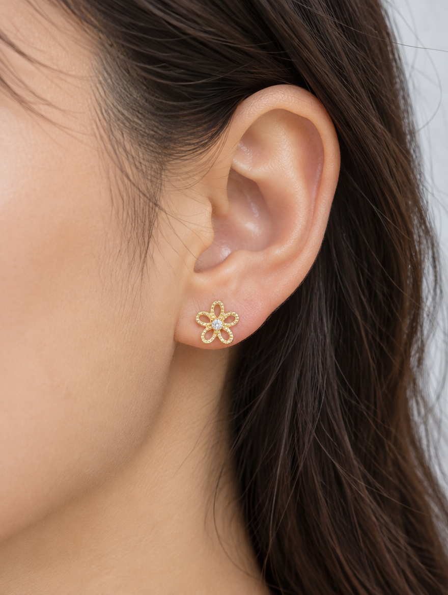 Woman wearing a gold flower stud earring