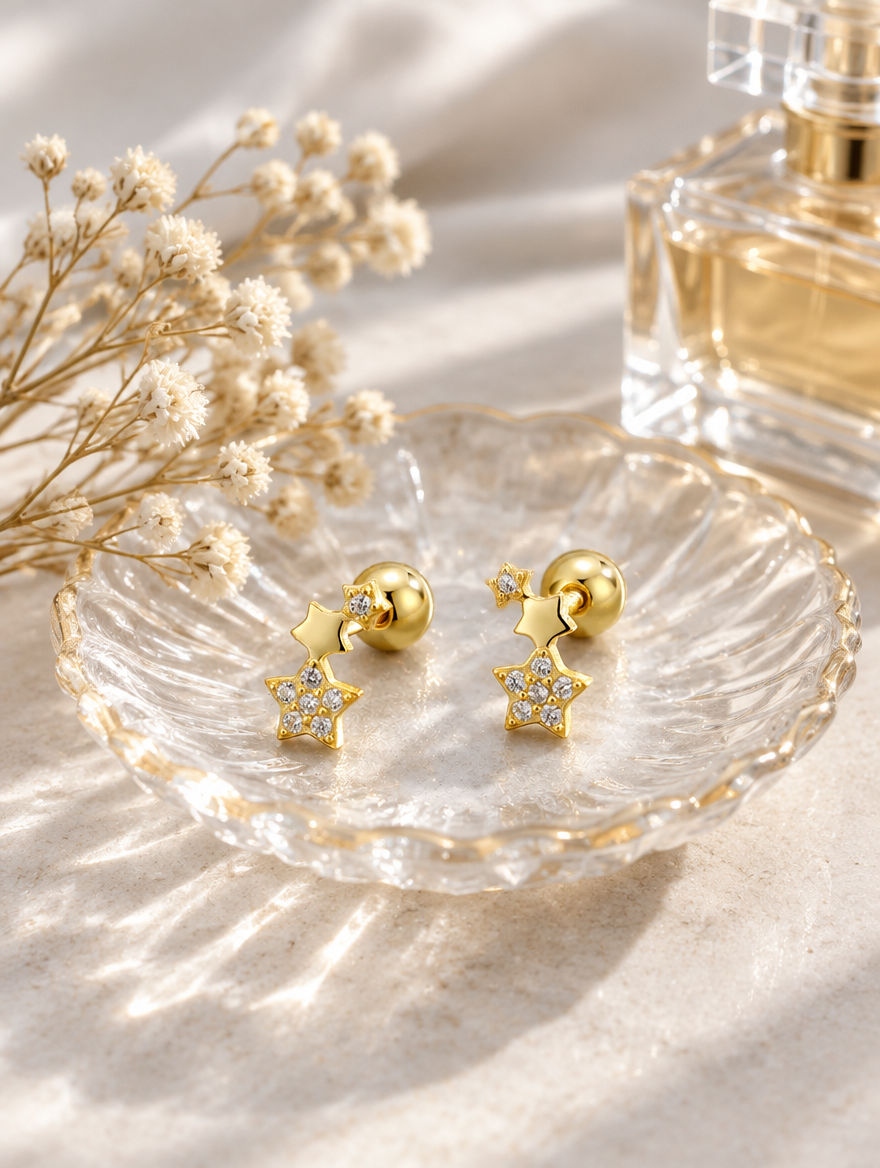 Gold star stud earrings in a styled still life with props