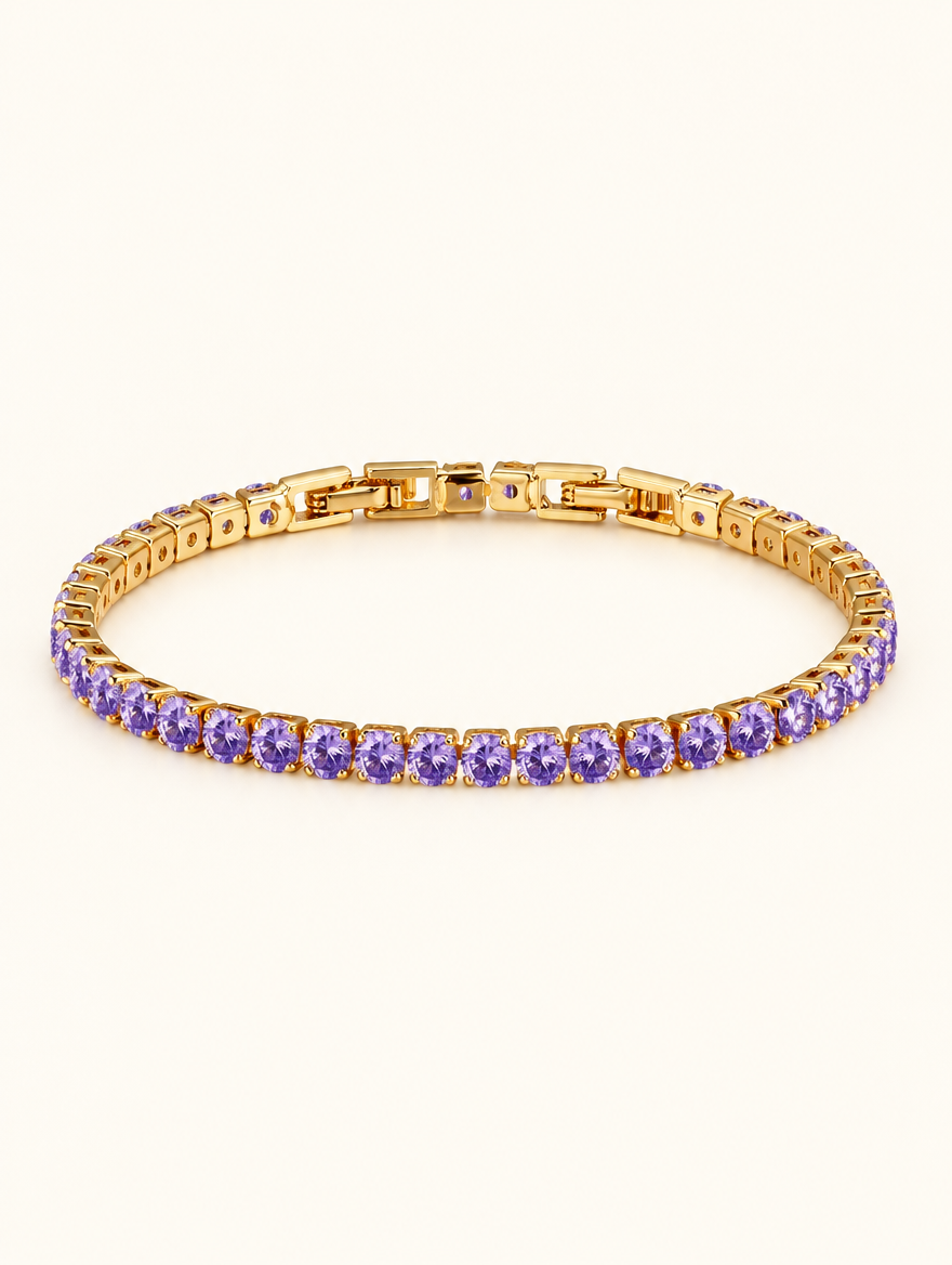 Gold tennis bracelet with purple zirconia stones on a neutral background