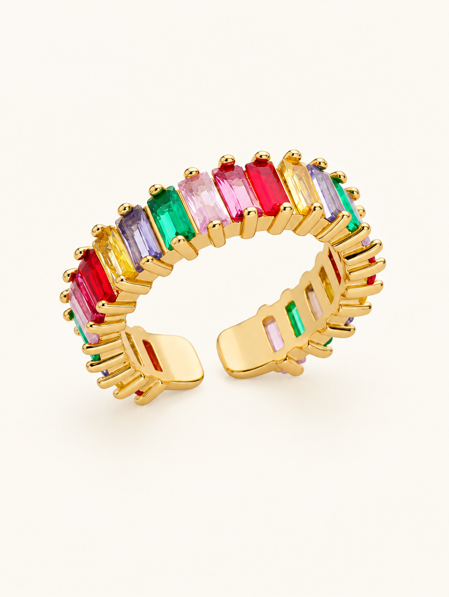 Gold rainbow baguette stone ring on a neutral background
