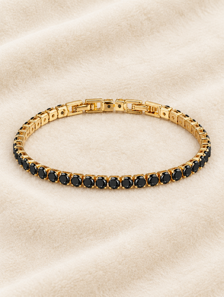 Gold black zirconia tennis bracelet on cream velvet