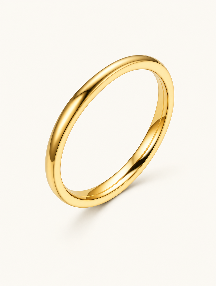 Thin gold polished band ring on a neutral background