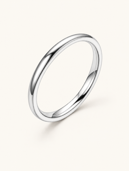 Thin silver polished band ring on a neutral background