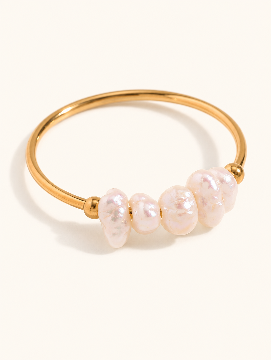 Gold freshwater pearl open ring on a neutral background