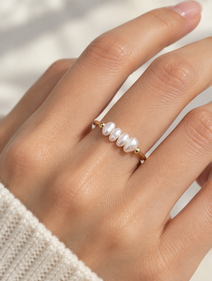 Woman wearing a gold freshwater pearl open ring on her finger