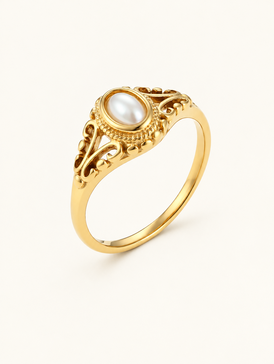 Gold vintage-style pearl ring on a neutral background