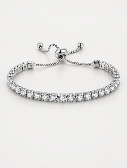 Silver slider tennis bracelet with clear zirconia stones on a neutral background