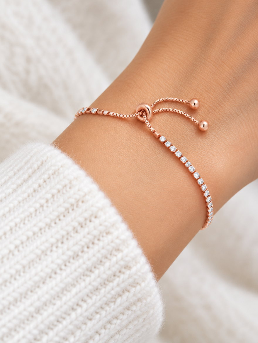 Woman wearing a rose gold slider tennis bracelet with clear zirconia stones