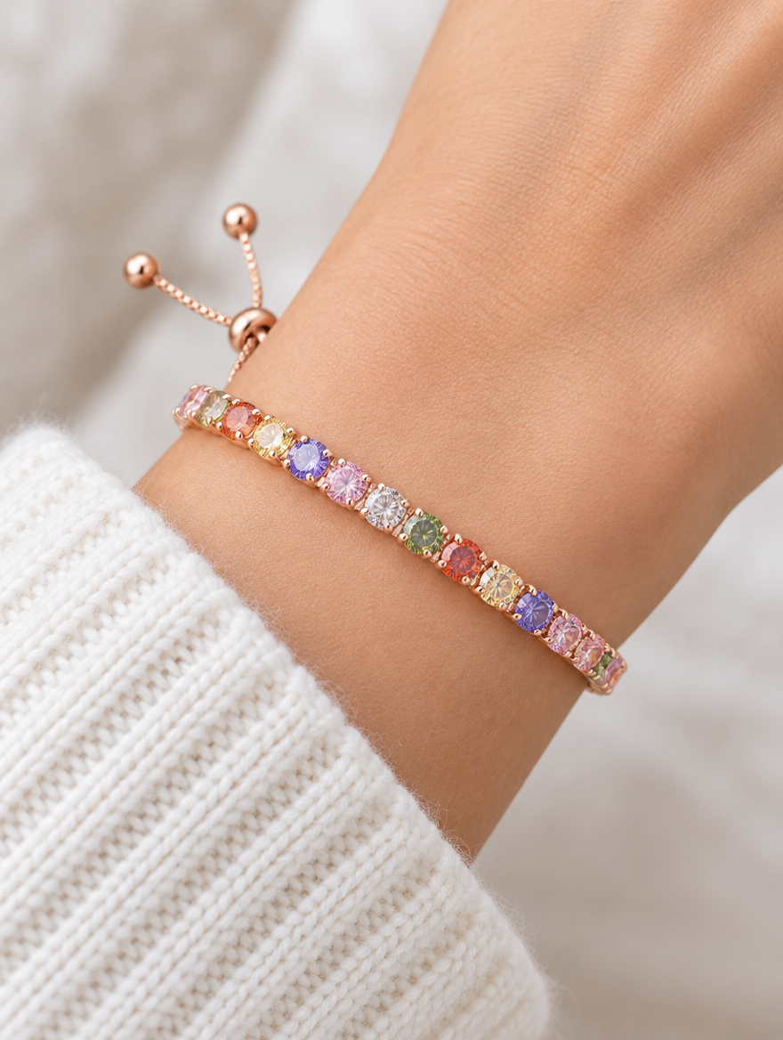 Woman wearing a rose gold slider bracelet with multicoloured zirconia stones