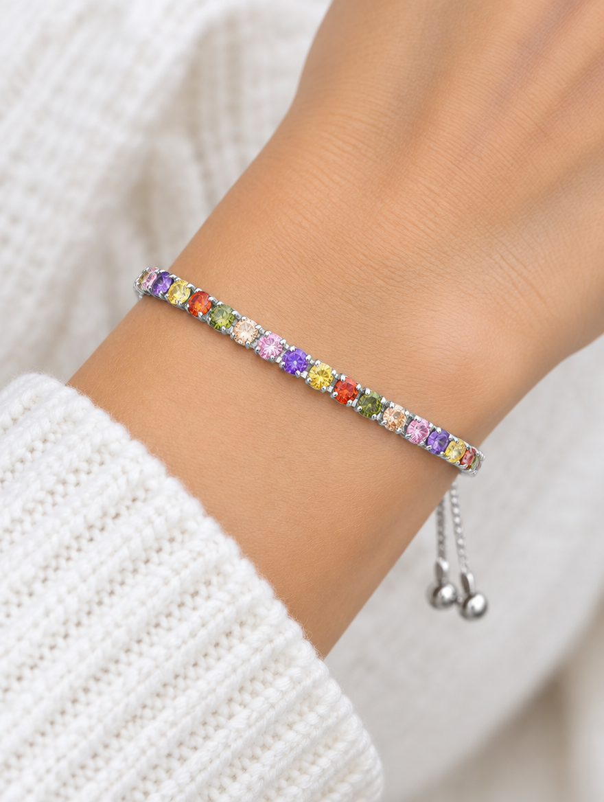 Woman wearing a silver slider bracelet with multicoloured zirconia stones