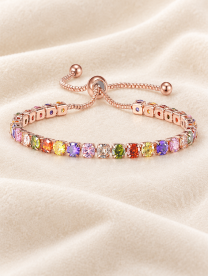 Rose gold rainbow zirconia slider bracelet on cream velvet