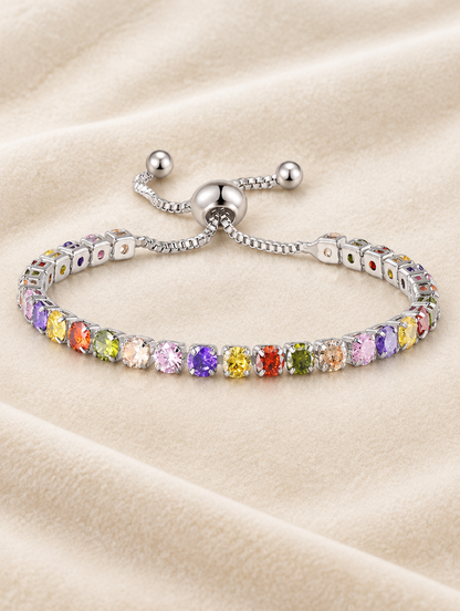 Silver rainbow zirconia slider bracelet on cream velvet