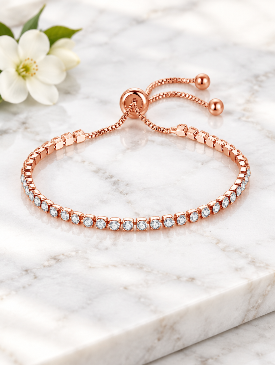 Rose gold zirconia bracelet beside a white flower on marble